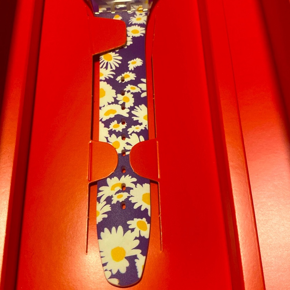 Swatch watch- women’s. Custom design. Purple with white daisies. Brand new.